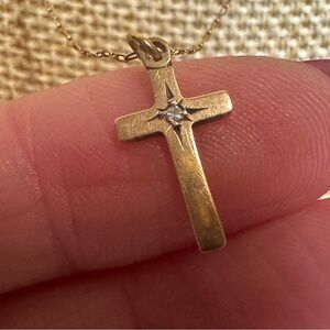 14kt yellow gold cross pendant with a diamond in the center on 14k chain